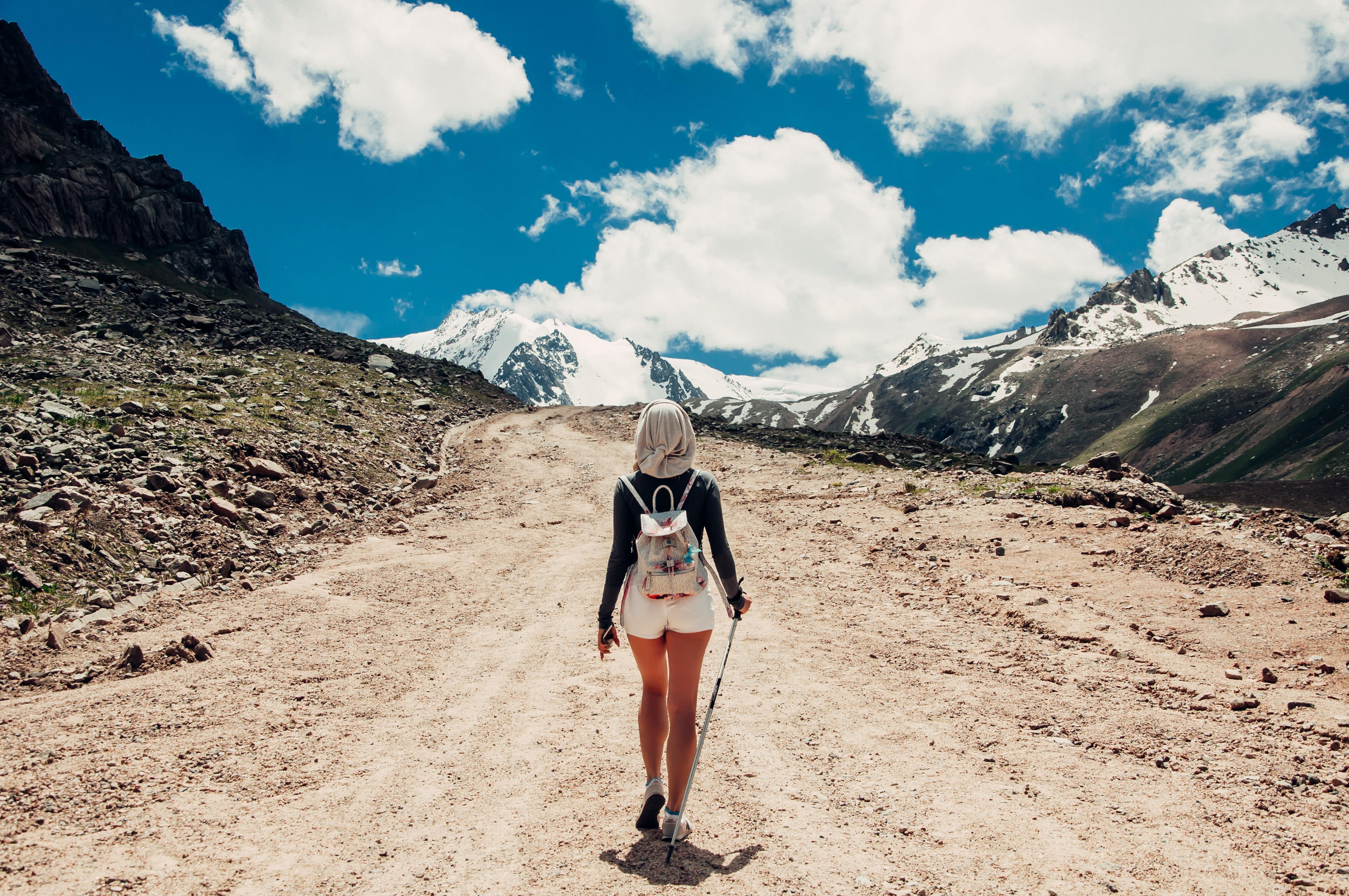 Woman Hiking with Trekking Poles On Mountain Trail | Pacific Rayne Gear